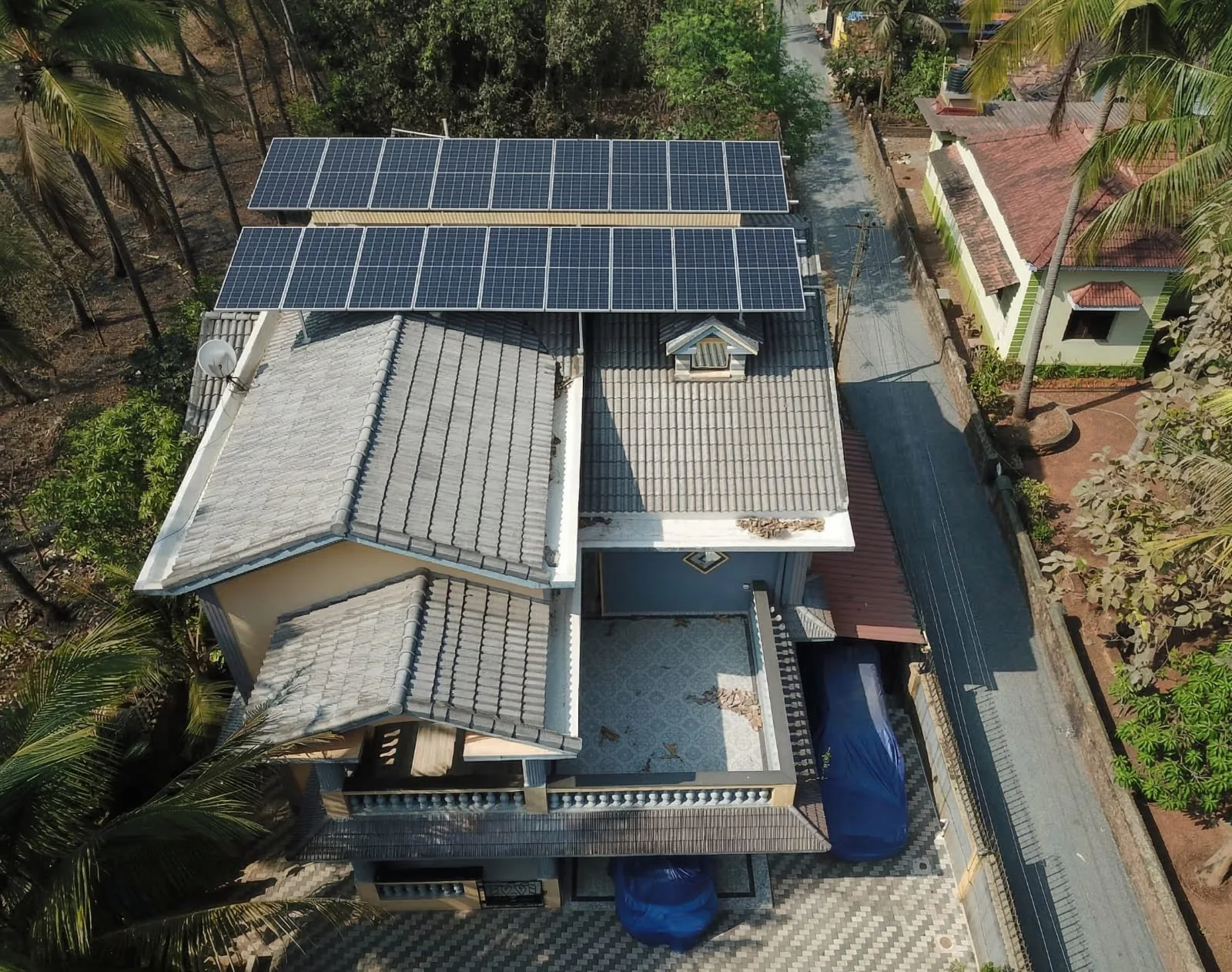 Elevated solar array over a grey-roof property